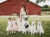 Bride with flower girls and dogs dressed up for the ceremony
